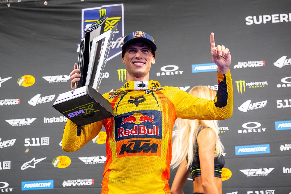 Prado smiles and holds the trophy after winning SMX Playoffs round two