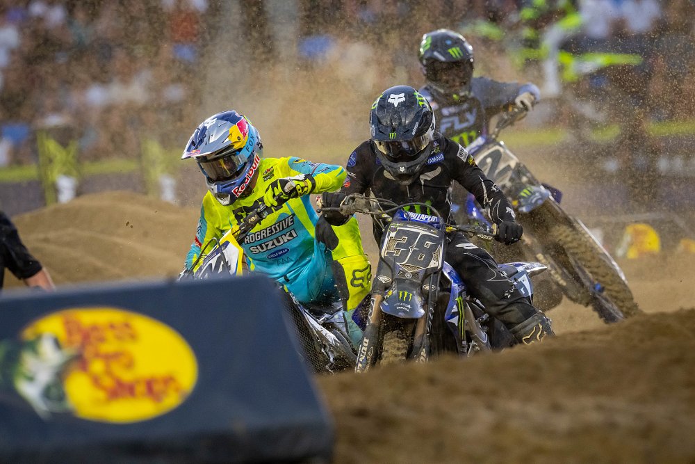 Roczen, Deegan, and Webb racing close together and fighting for position as sand flies in round two