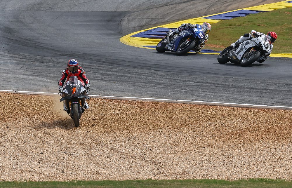 Beaubier running off track into the gravel trap at Road Atlanta as other racers continue on