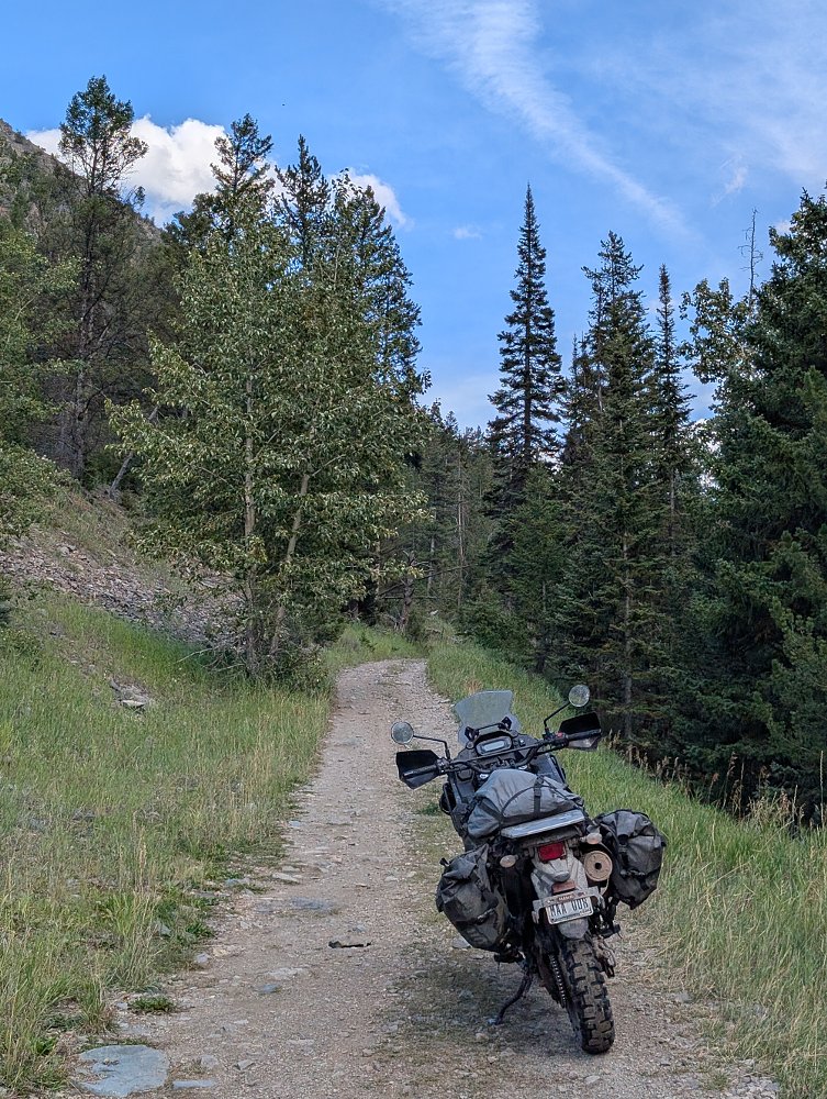 KLR on a narrow two-track mountain trail