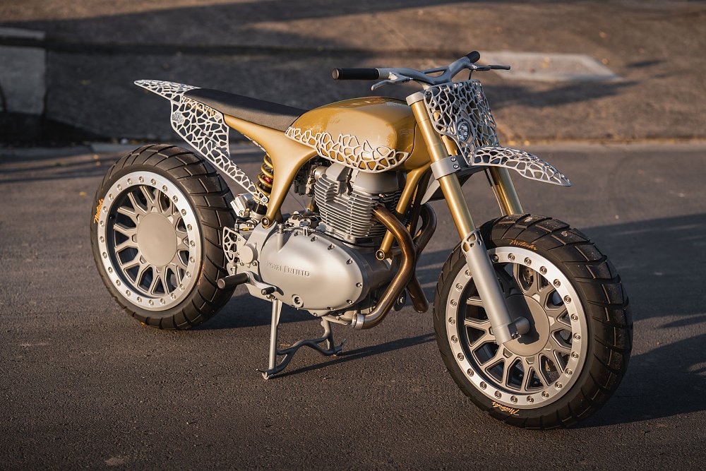 modified Bear 650 in gold color with white, lattice-style metalwork over the bodywork