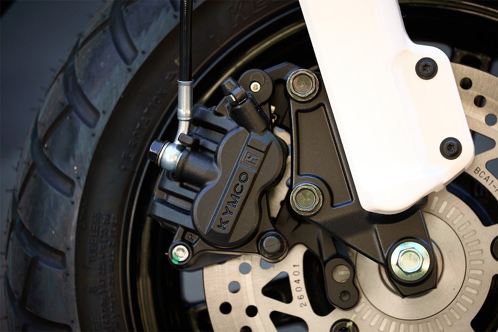 A close up of the Honcho's Kymco-branded front brake caliper.