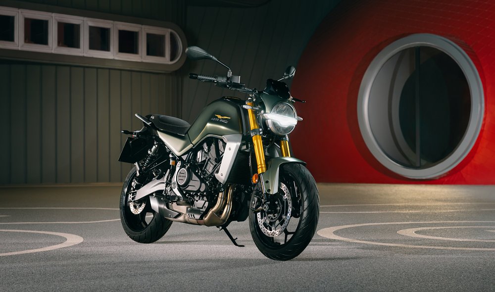 image of the green and silver roadster style motorcycle in front of the famed Moto Guzzi wind tunnel