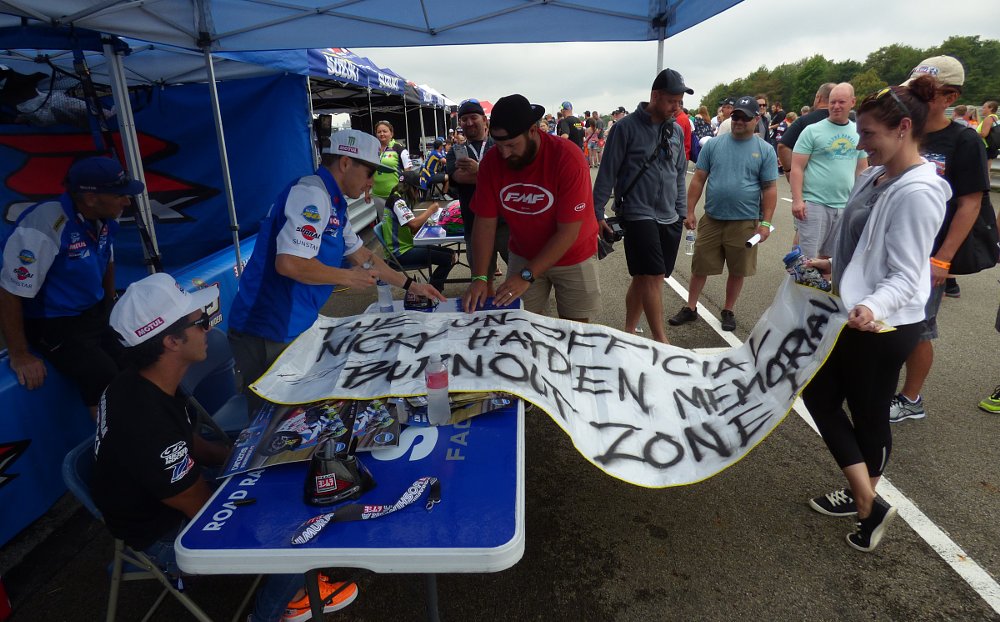 Roger Hayden signs a poster