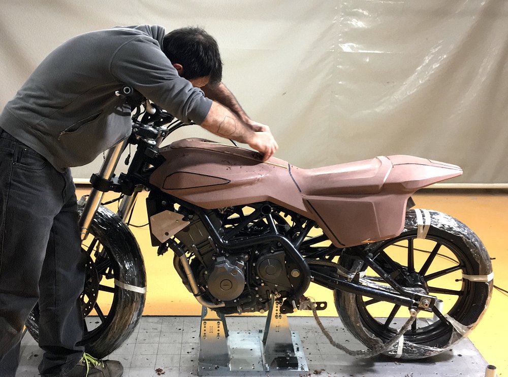 shaping a clay mockup of the XR338