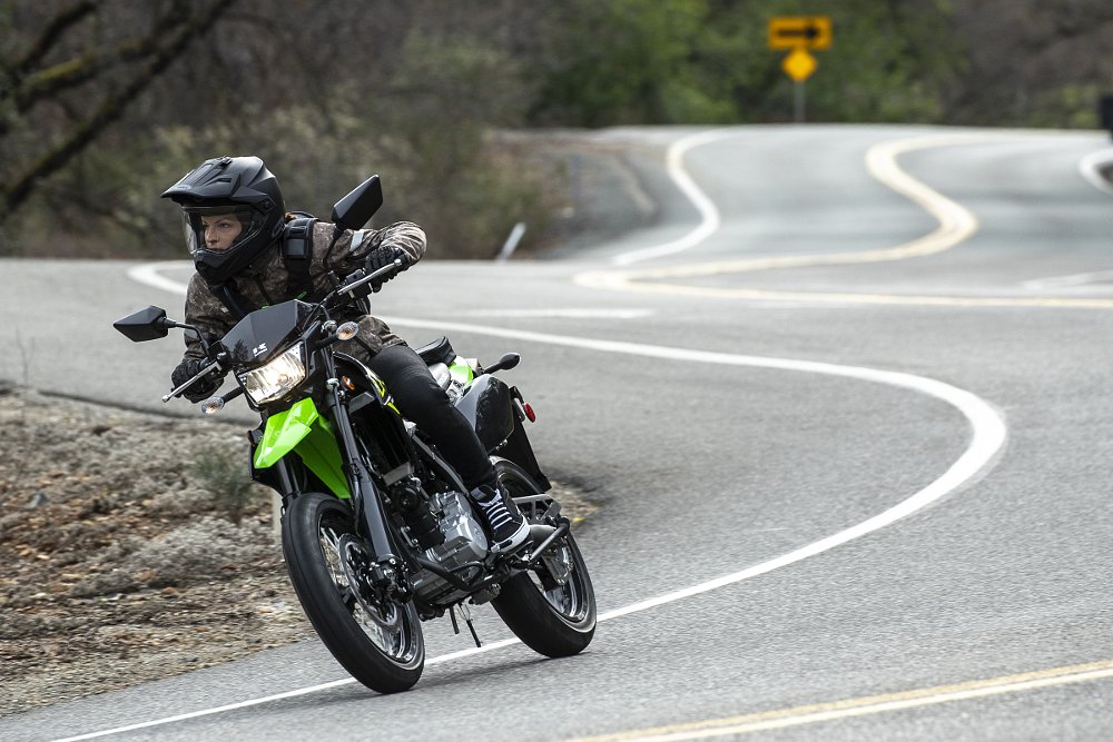 riding the KLX300SM on a curvy road