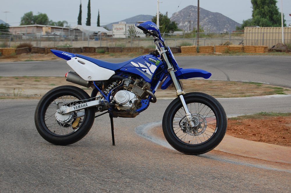 The Yamaha TT-R 125 with supermoto wheels posed on the go kart track