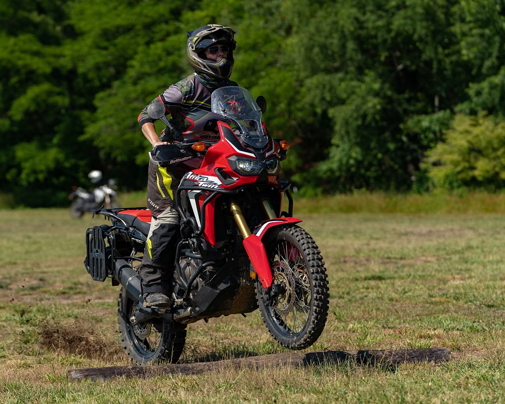 coach demonstrates riding over a log