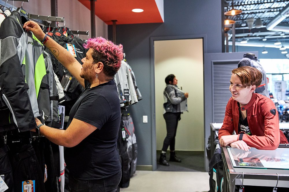 Diego pulls jackets off the rack