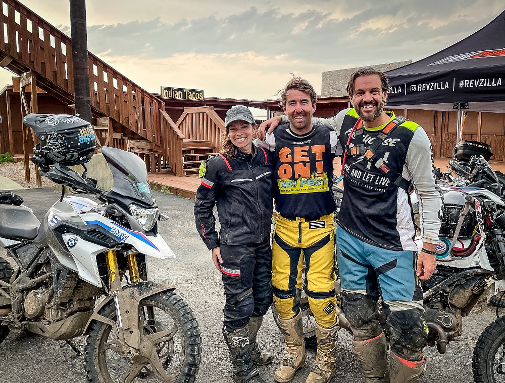 Three ADV riders gather together for a group photo after a long ride.