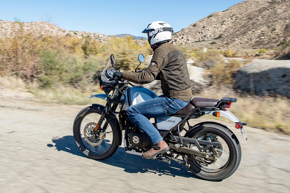2022 Royal Enfield Himalayan left-side tracking shot on a paved road in the desert.