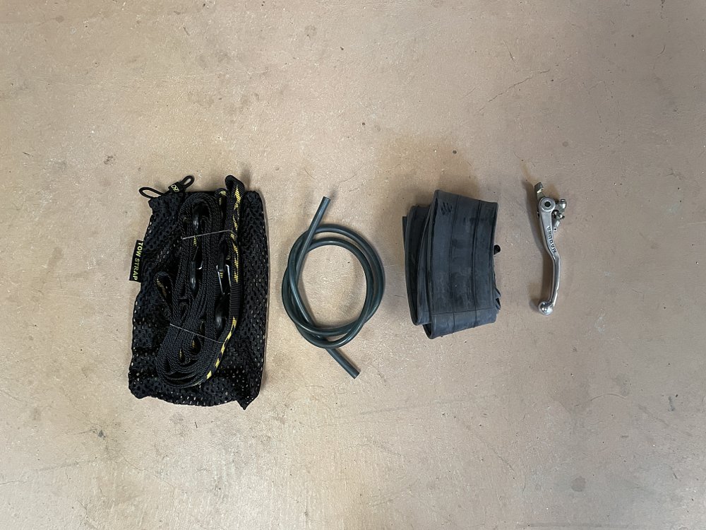 A top down view of various spare parts for the motorcycle.