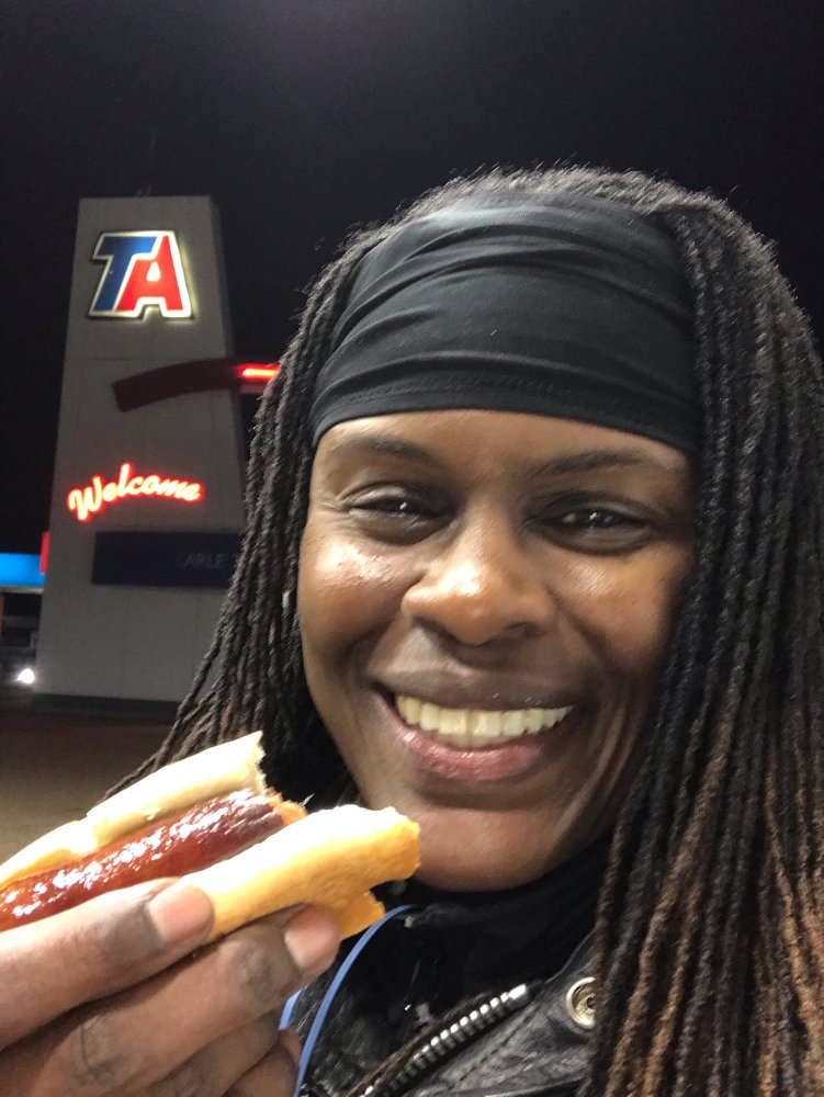 eating a hot dog in the dark at a truck stop