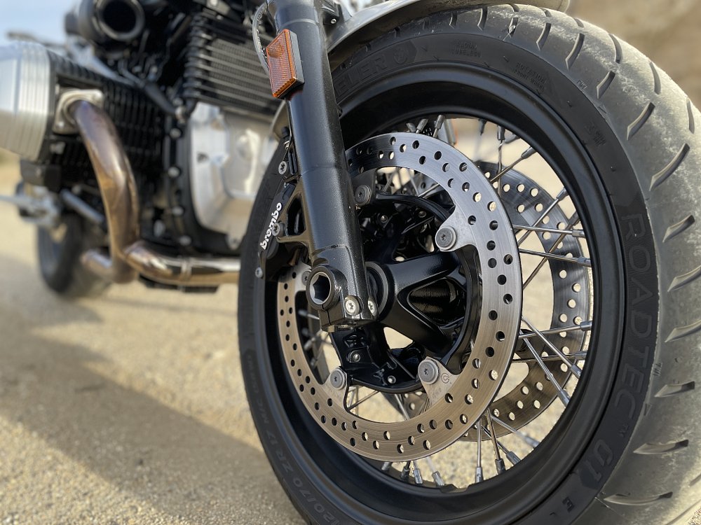 A close up view of the front tire and front brake rotor on the BMW R nineT Pure.