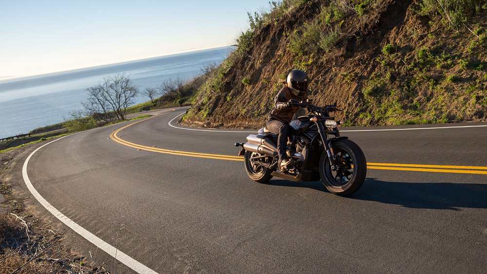 A female rider rides the Sportster S on a scenic ocean view road in Malibu California
