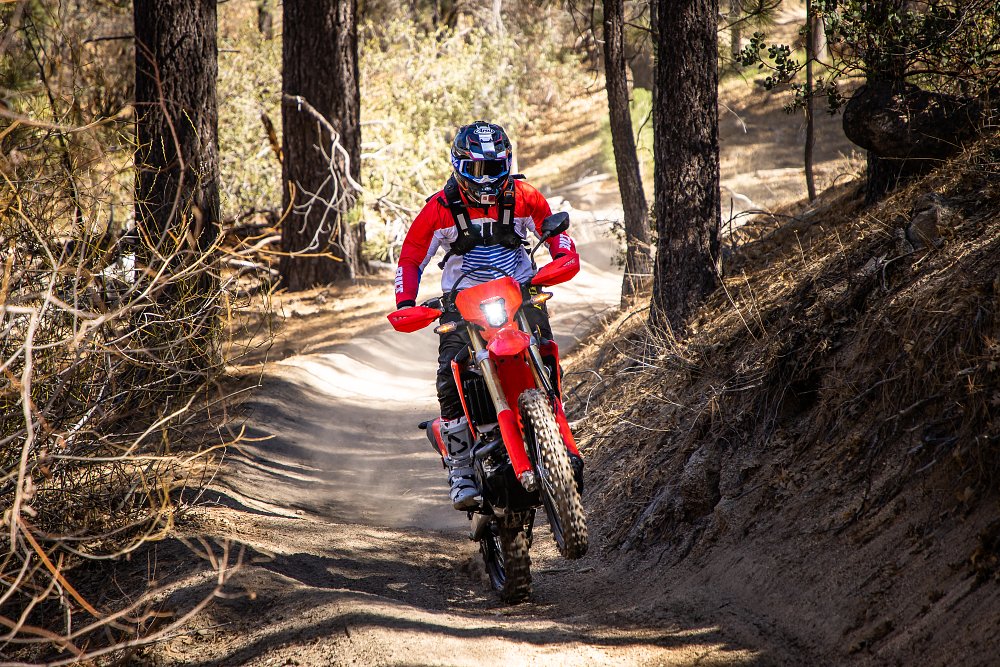 2022 CRF450RL wheelie on singletrack trail.