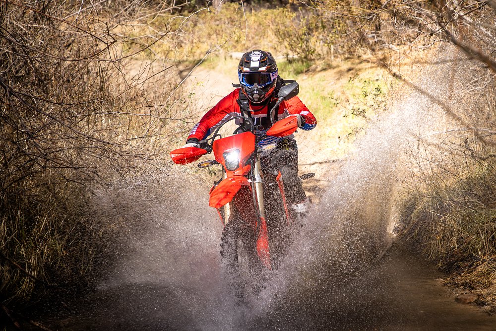 CRF450RL blasting through water.