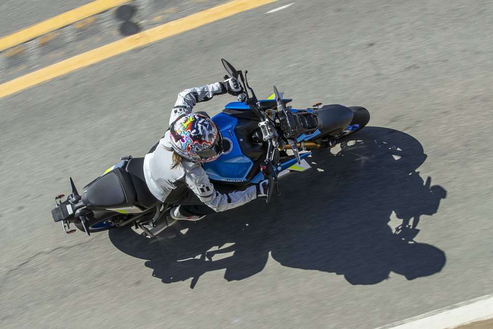 A top down view of a female rider piloting the GSX-S1000 on a mountain road in Malibu