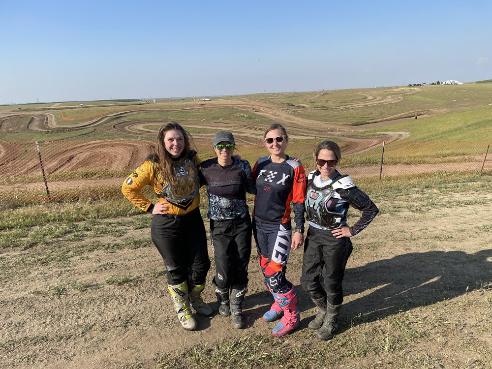 4 female riders pose for a group shot together