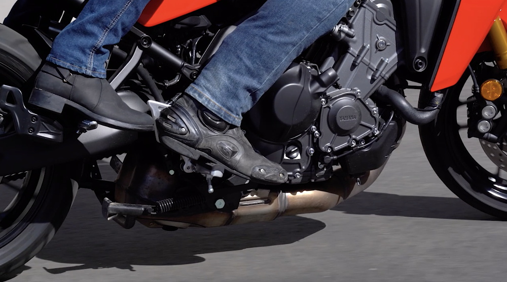 Using the rear brake on a motorcycle. 