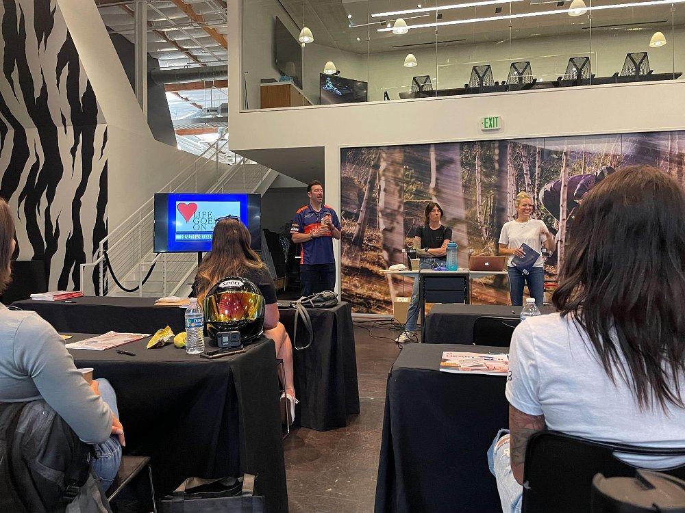 3 individuals stand in front of a classroom during introductions