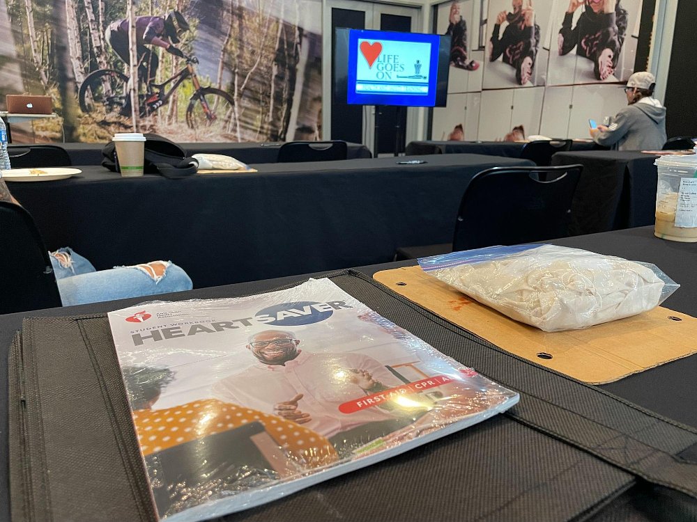 A close up of a first aid manual booklet and first aid supplies