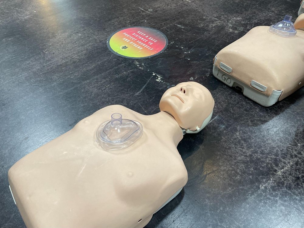 A close up of the CPR mannequin and the recommended PPE face mask for administering breaths