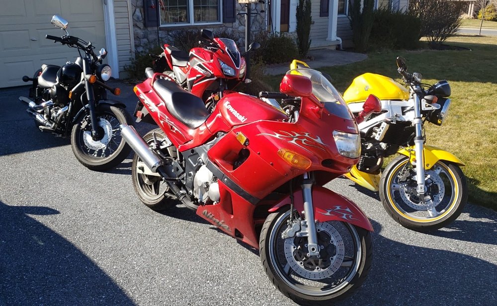 four motorcycles parked in the driveway of the family home