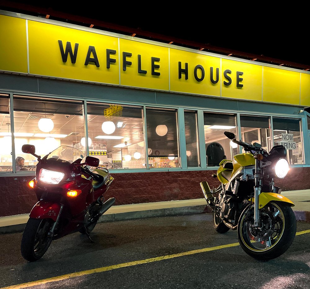 motorcycles parked outside a Waffle House at night