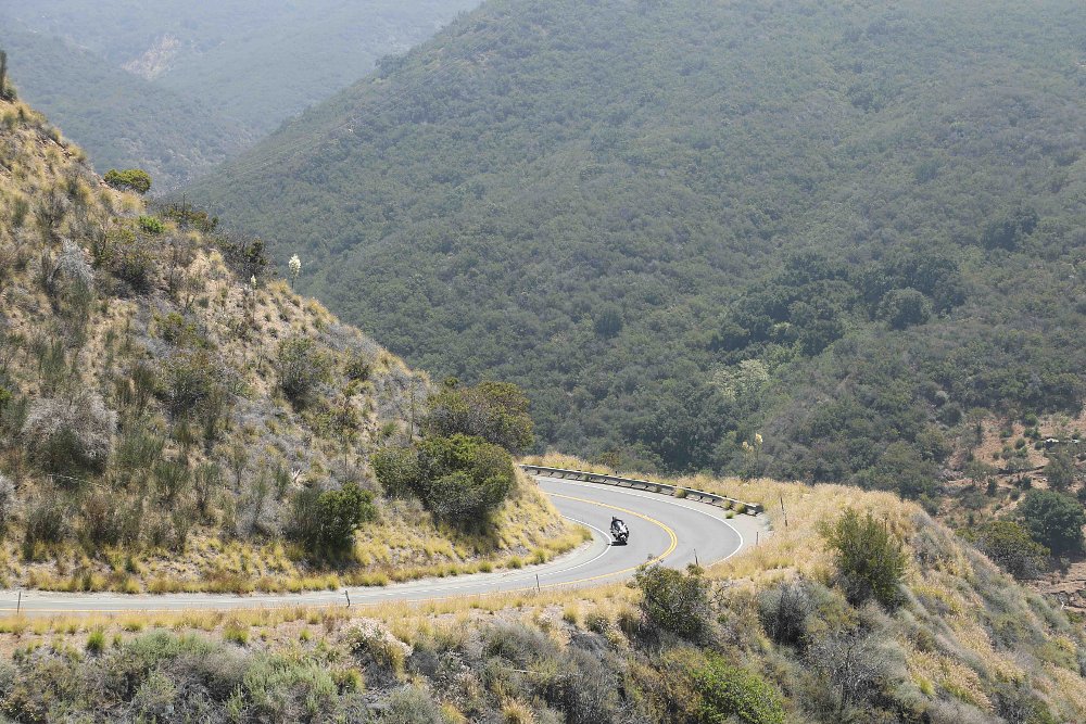 2022 BMW R 1250 RT-Police from far away, riding on an empty mountain road.