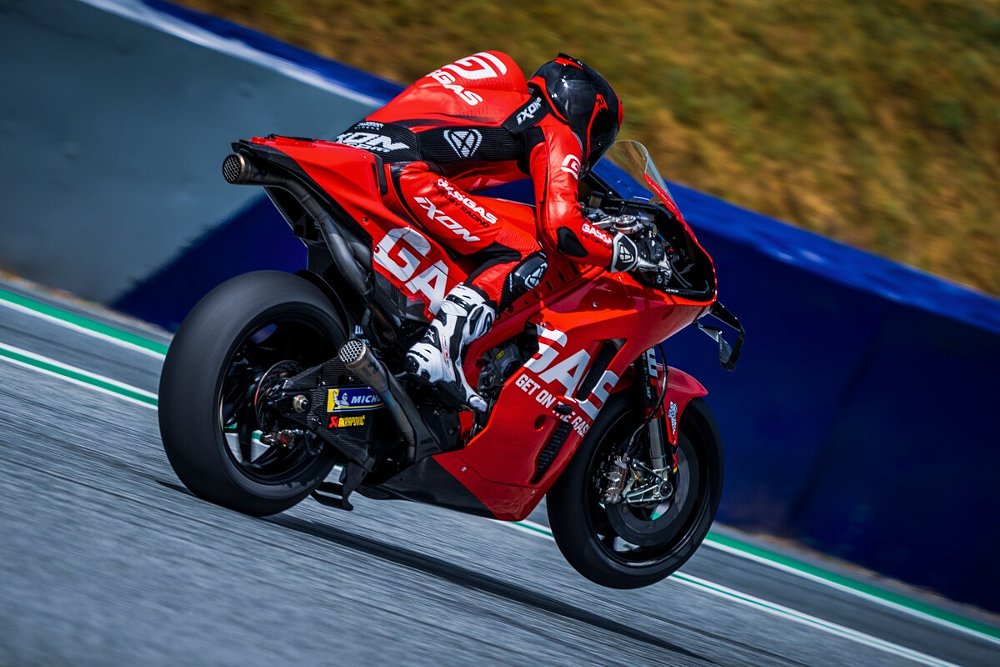 An wheelie photo of the red GasGas Motogp racing bike in action