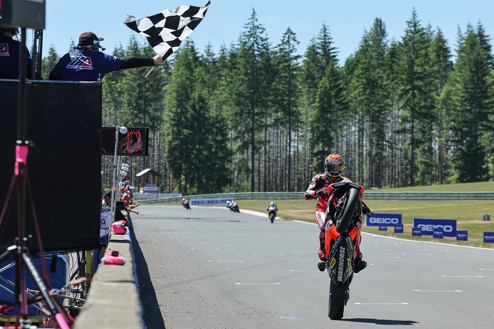 Herrin doing a wheelie past the checkered flag on the Ducati Panigale V2