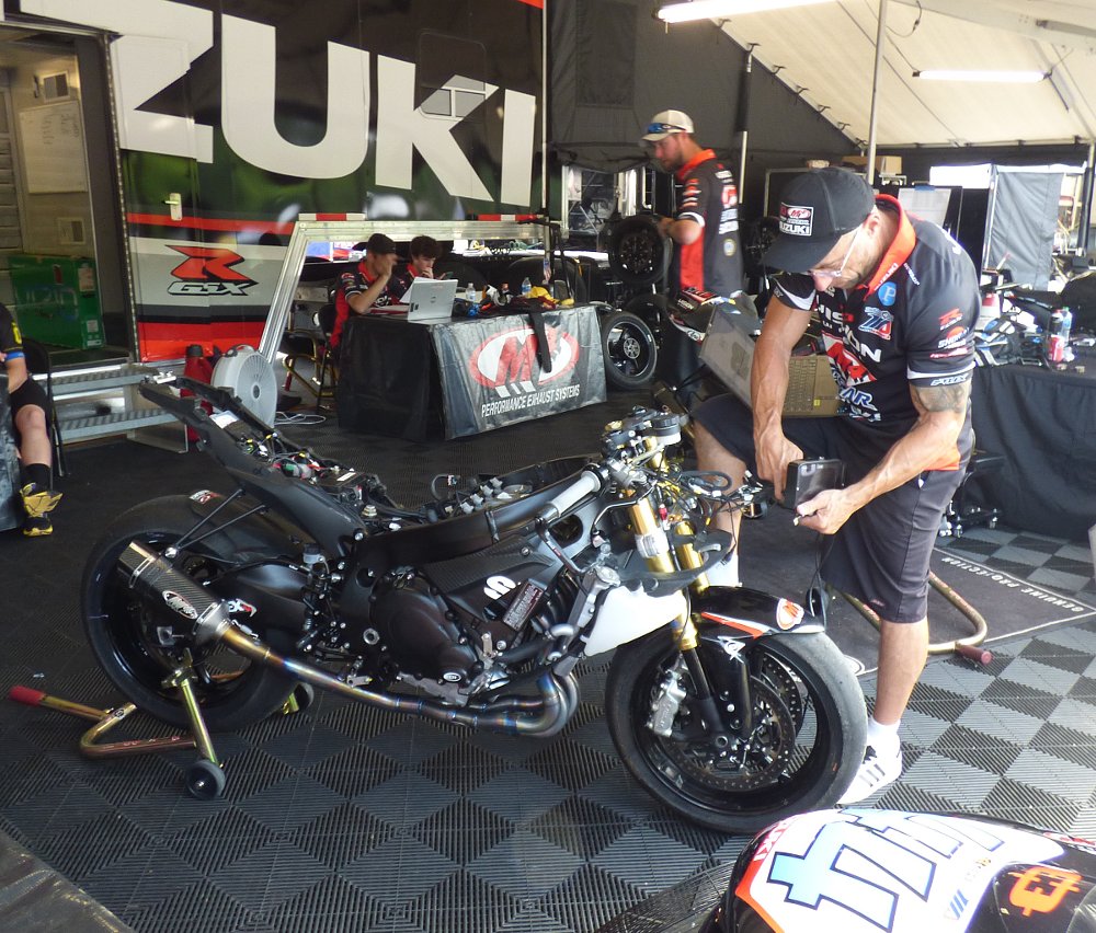 mechanic working on a stripped-down GSX-R750