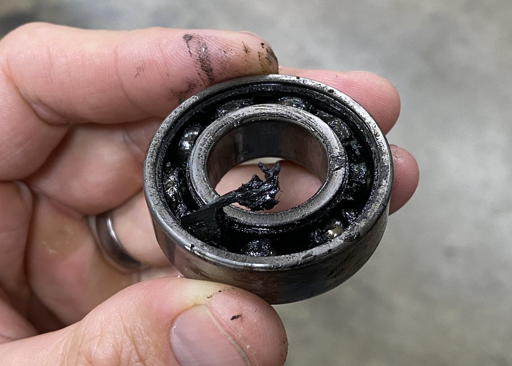 Worn and damaged wheel bearing.