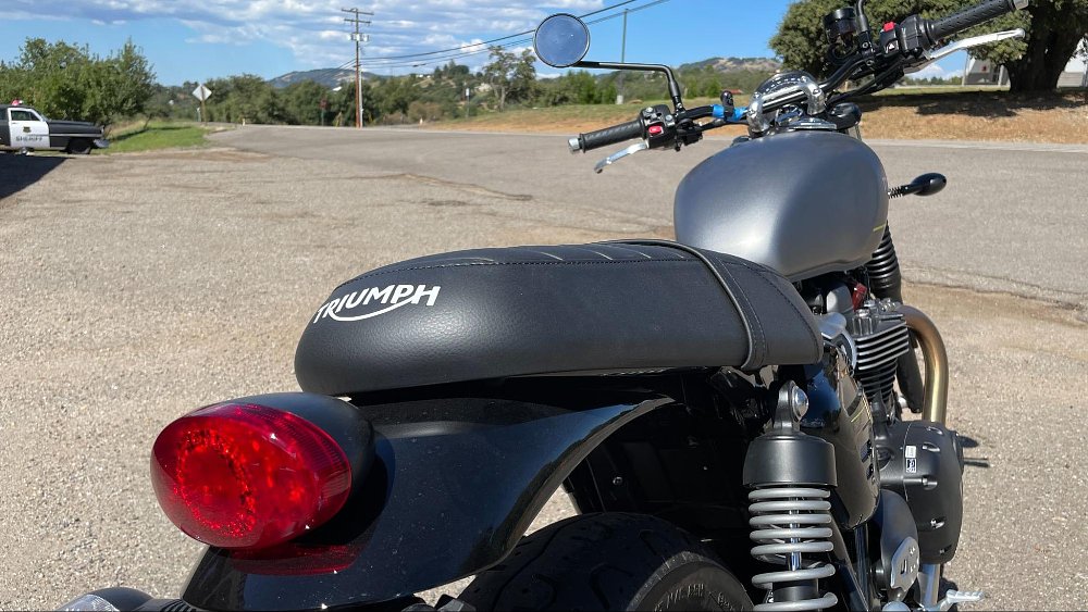A close up view of the black leather padded seat on the Triumph Speed Twin 900 motorcycle