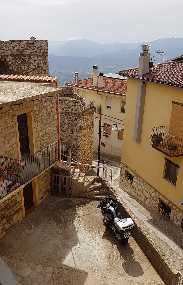 BMW parked on a steep hillside landing