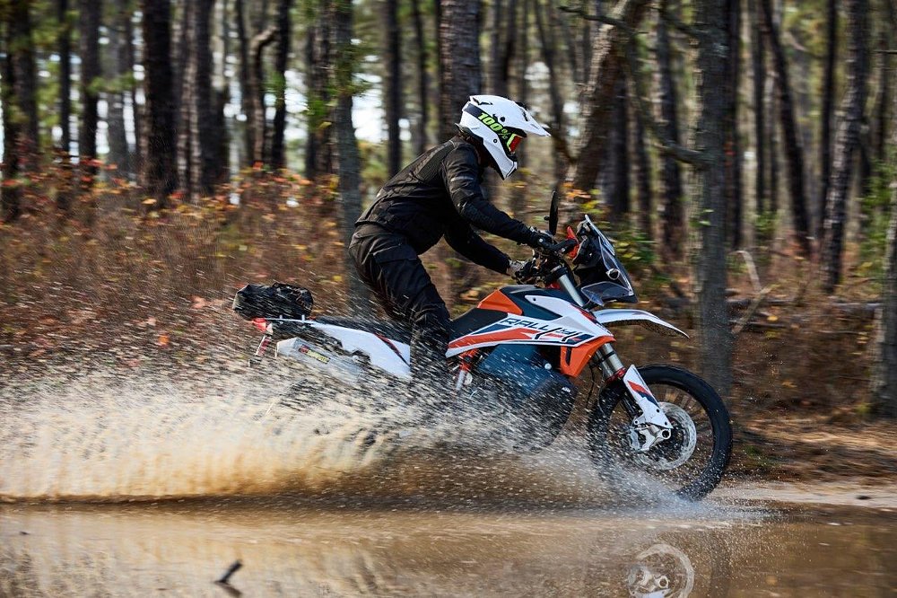 Spurgeon riding his KTM through a water crossing