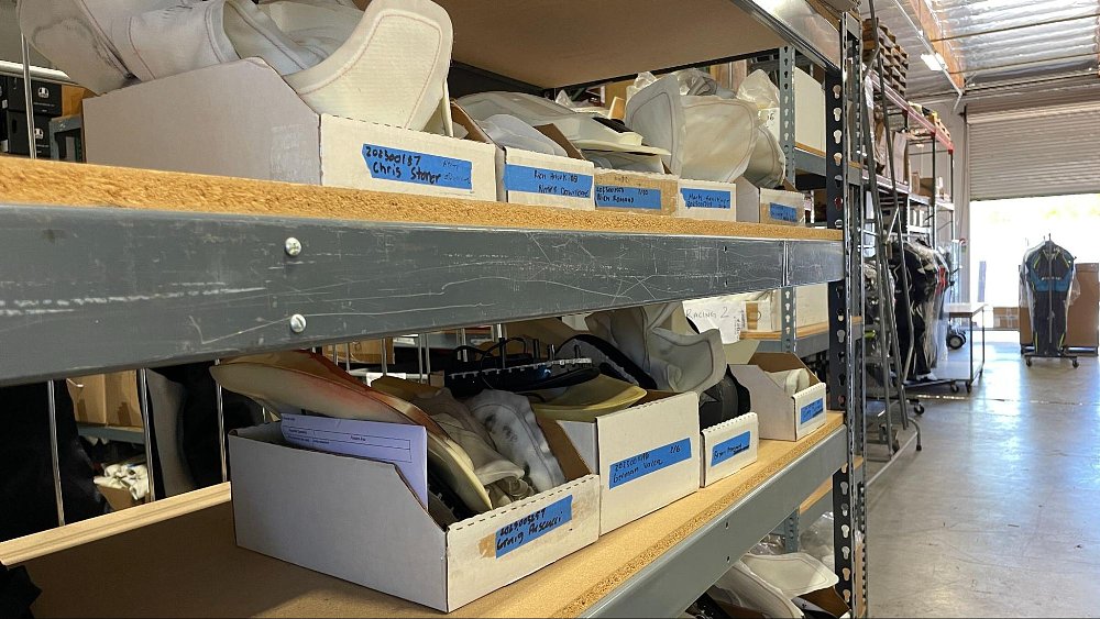 a photo of rows of Dainese air bag systems on racks waiting for testing