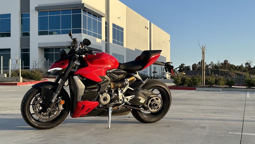 2023 Ducati Streetfighter V2 left side, parked in front of an office building.