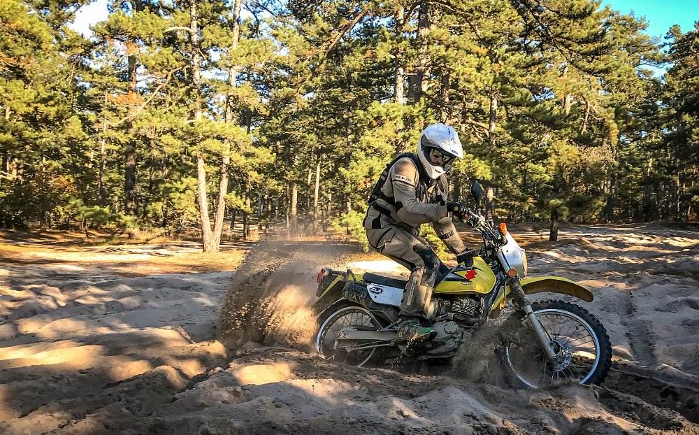 riding a dirt bike in sand