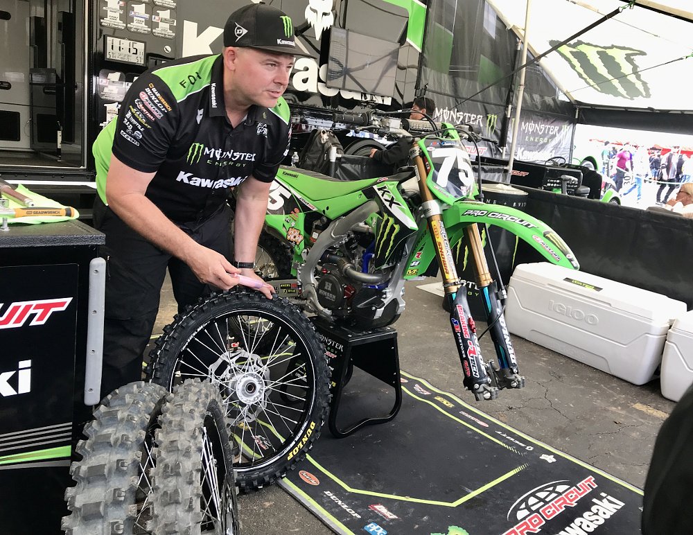 mechanic working on a race bike in the paddock