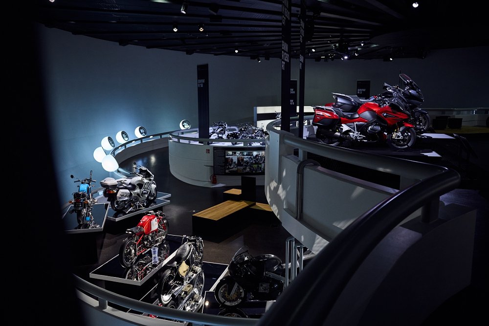 motorcycles on display inside the curved hall of the museum