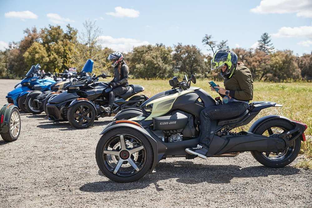 Jen sits on the Ryker and checks her Rever map on her phone