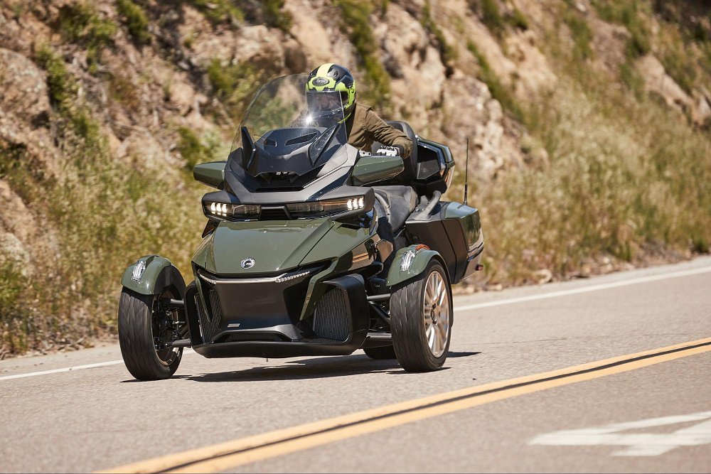 Jen pilots the can-am spyder sea-to-sky edition in green on a mountain road