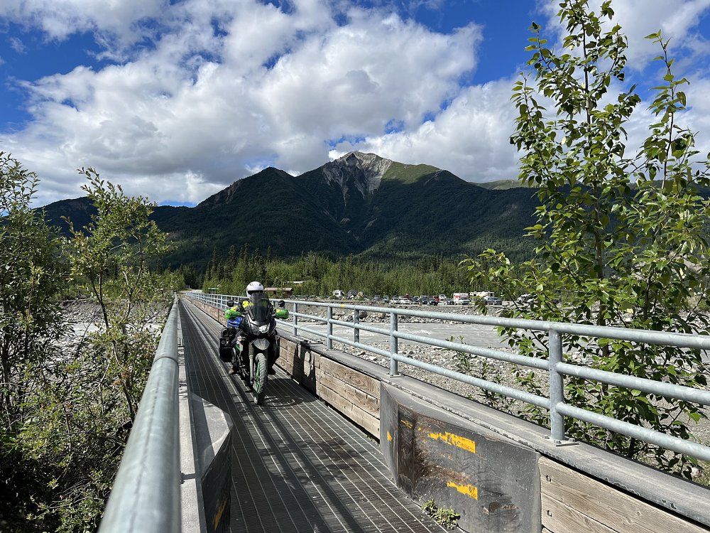riding across the narrow bridge on a motorcycle at the end of the McCarthy Road