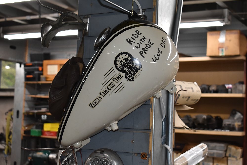 gas tank signed by Dale, saying 'RIDE WITH PRIDE LOVE DAD' 