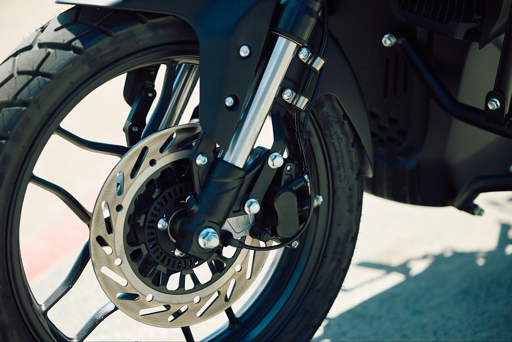 a close up view of the front brakes and suspension on the RX1E