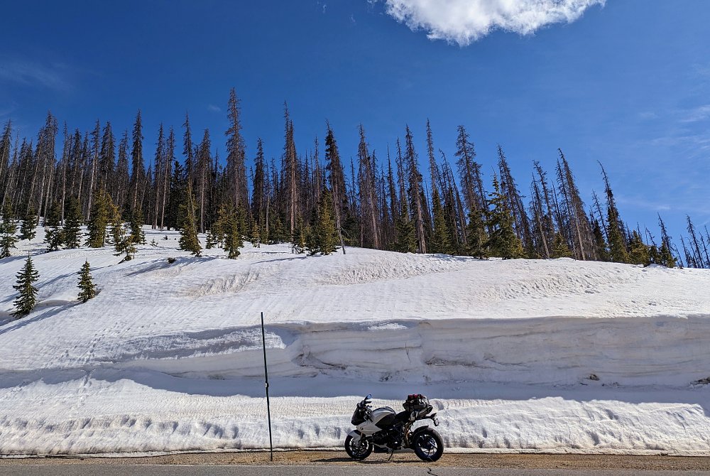 BMW HP2 Sport parked in front of a massive roadside snowbank