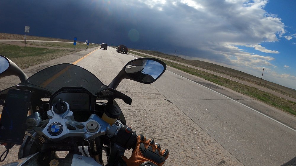 rider's perspective view riding the HP2 Sport toward a big storm on the horizon