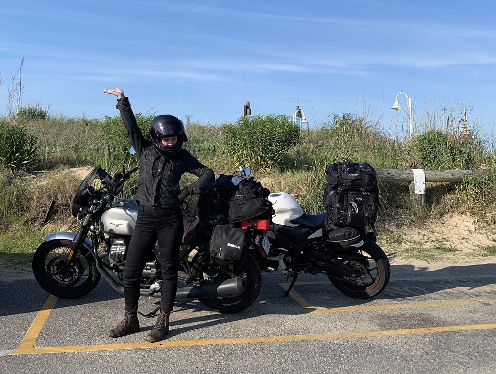 posing in front of the motorcycles parked by the dunes of the ocean